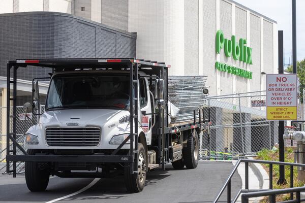 Workers put up fences around the parking deck that collapsed at the Summerhill Publix on Saturday.
