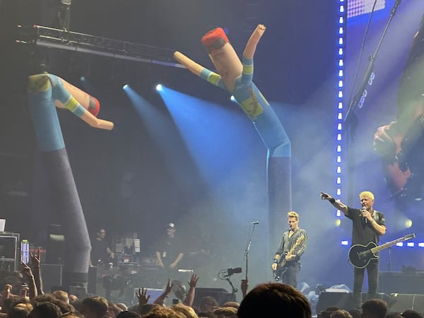 The Offspring concert at Ameris Bank Amphitheatre featured no shortage of props, including streamers, oversize beach balloons, a fire display, a drone-led dirigible and four inflatable tube men. (Rodney Ho/AJC)
