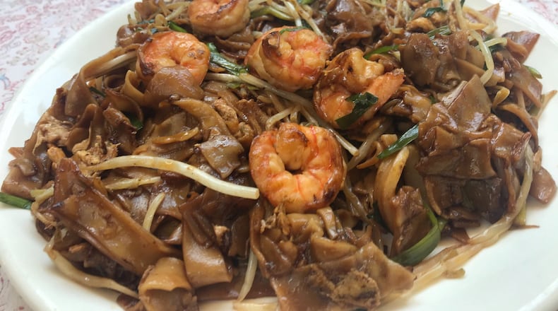 The chow kway teow is a filling, flavorful and affordable plate of flat rice noodles studded with shrimp, squid, eggs and bean sprouts. LIGAYA FIGUERAS / LIGAYA.FIGUERAS@AJC.COM