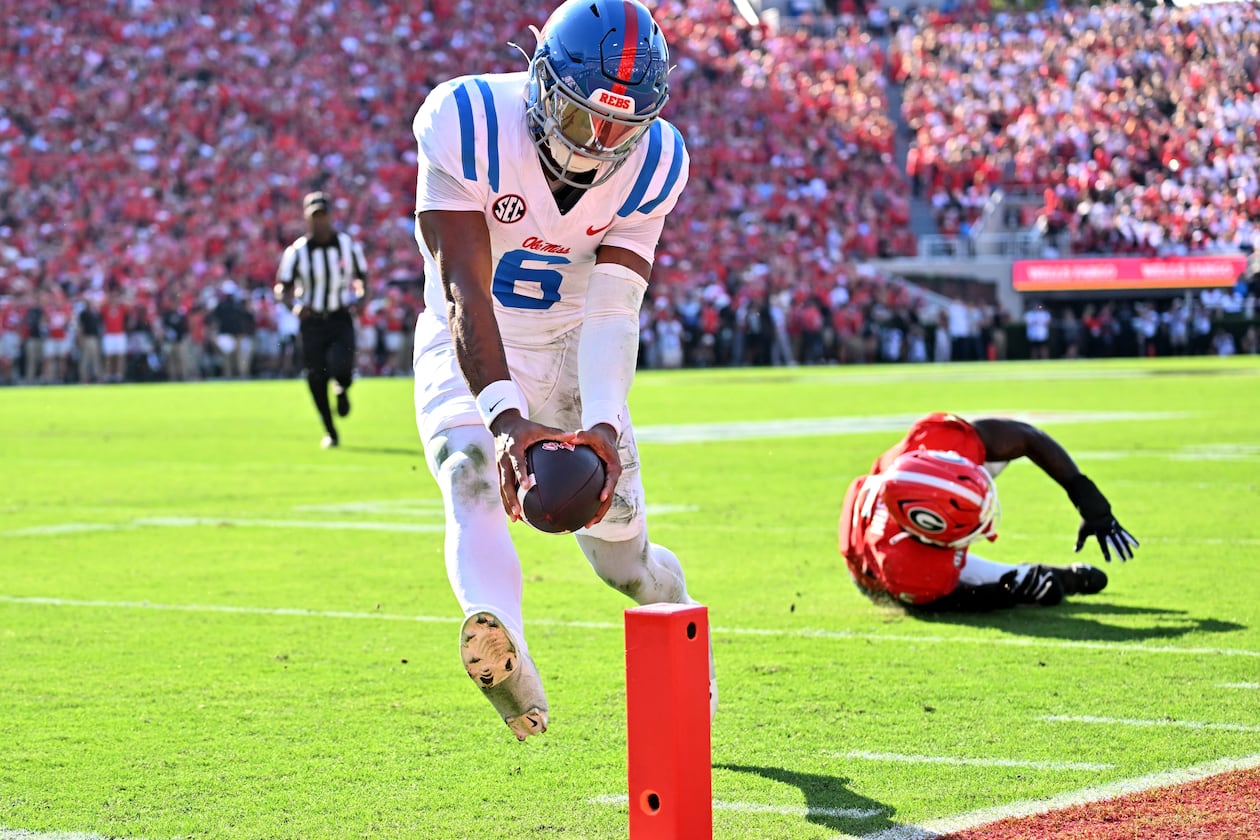Mississippi quarterback Trinidad Chambliss runs past Georgia linebacker Raylen Wilson for a touchdown during the first half of Saturday's game at Sanford Stadium. (Hyosub Shin/AJC)