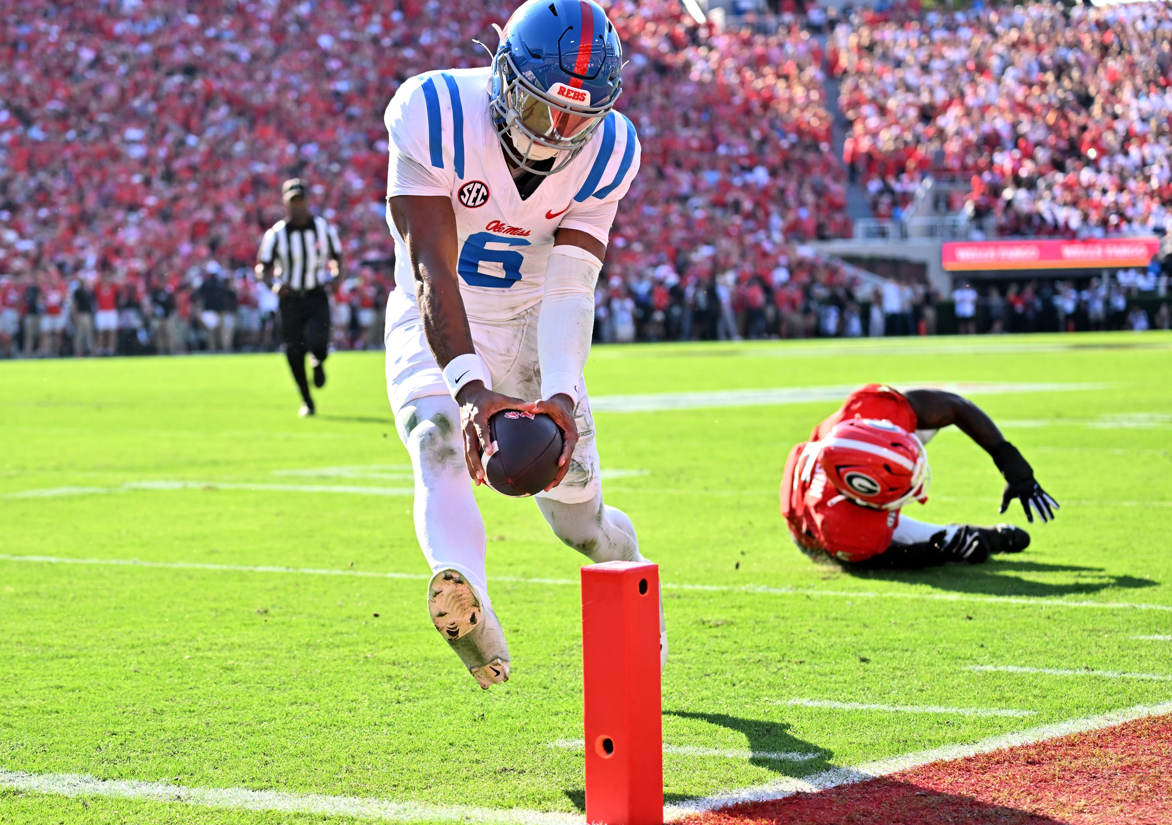 Mississippi quarterback Trinidad Chambliss (6) runs past Georgia linebacker Raylen Wilson (5) for a touchdown during the first half in an NCAA football game at Sanford Stadium, Saturday, October 18, 2025, in Athens. (Hyosub Shin / AJC)