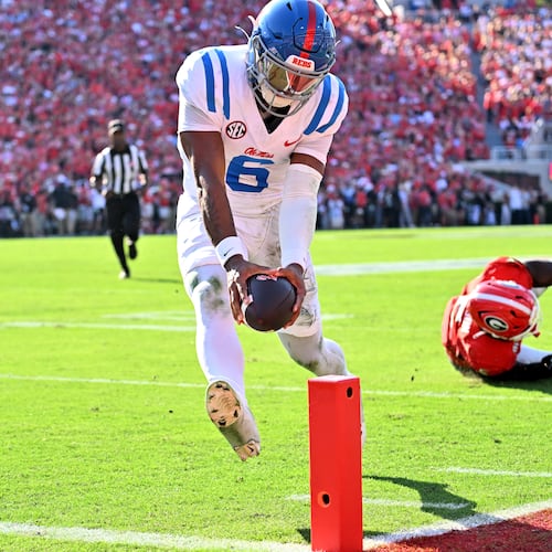 Mississippi quarterback Trinidad Chambliss runs past Georgia linebacker Raylen Wilson for a touchdown during the first half of Saturday's game at Sanford Stadium. (Hyosub Shin/AJC)