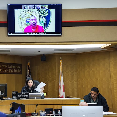 Former NFL star wide receiver Antonio Brown, on monitor above, appears for his bond hearing via video after his attorney Mark Eiglarsh, left, filed a written plea of "not guilty" for an attempted murder charge as Judge Mindy S. Glazer presides, Wednesday, Nov. 12, 2025, in Miami. (Carl Juste/Miami Herald via AP, Pool)