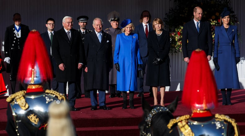 On the stage from left, German President Frank-Walter Steinmeier, Britain's King Charles III, Queen Camilla, wife of Steinmeier Elke Buedenbender, Prince William and Kate, Princess of Wales, attend a welcome ceremony on the Royal Dais at Datchet Road, in Windsor, England, Wednesday, Dec. 3, 2025. (Toby Melville/Pool Photo via AP)