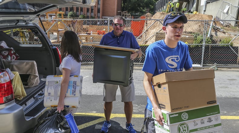 Georgia Tech student Carter Floyd-19 (right) came early to move in at the Eighth Street Apartments on campus on Monday, Aug. 15, 2016 with his parents, Stephen and Laurie.