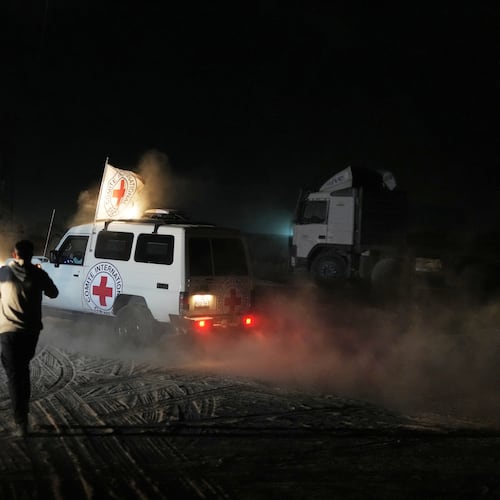Red Cross convoy carrying the body of a person believed to be a deceased hostage handed over by Hamas militants makes its way toward the border crossing with Israel, to be transferred to Israeli authorities, in Deir al-Balah, central Gaza Strip, Thursday, Nov. 13, 2025. (AP Photo/Abdel Kareem Hana)