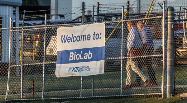 Workers at BioLab are seen after the fire.