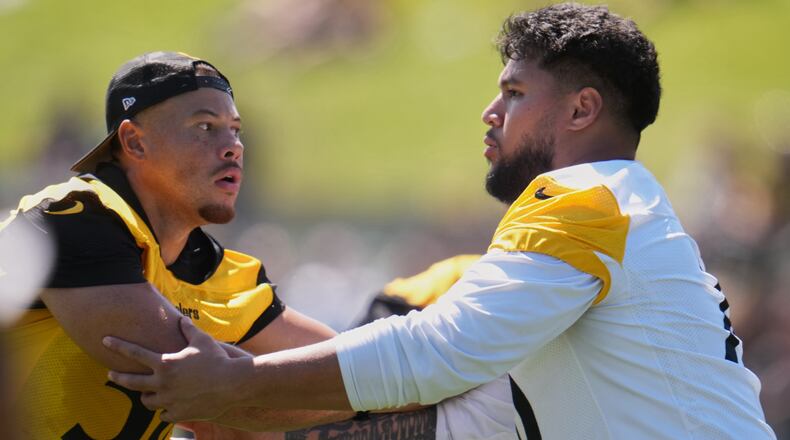 Pittsburgh Steelers linebacker Alex Highsmith (56), left, is blocked by offensive tackle Troy Fautanu during the team's NFL football training camp in Latrobe, Pa., on Friday, July 31, 2026.(AP Photo/Gene J. Puskar)