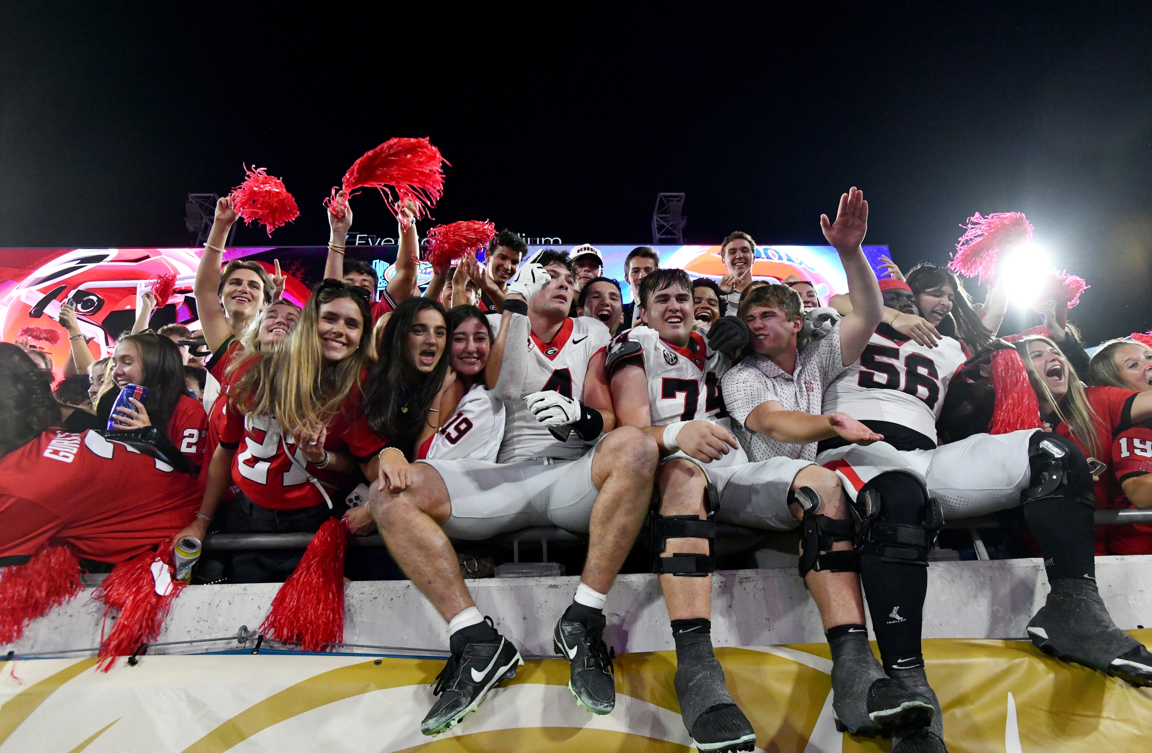 Georgia players celebrate with fans after Georgia beat Florida during an NCAA football game, Saturday, November 1, 2025, Jacksonville, Fla. Georgia won 24-20 over Florida. (Hyosub Shin / AJC)