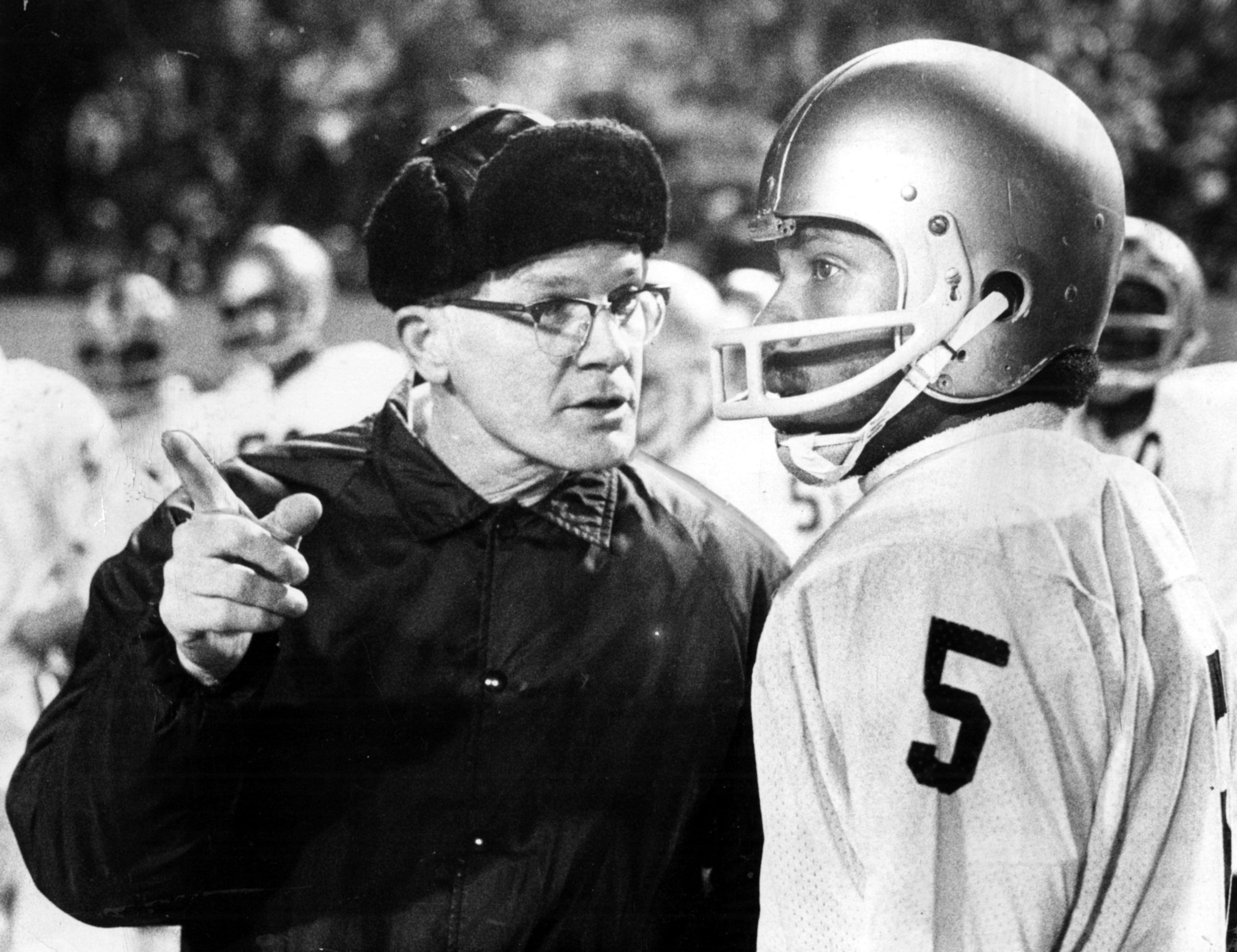 Douglass High School head football coach Charlie Brannon and quarterback Stanley Driskell plan their play in December 1975. (AJC file)