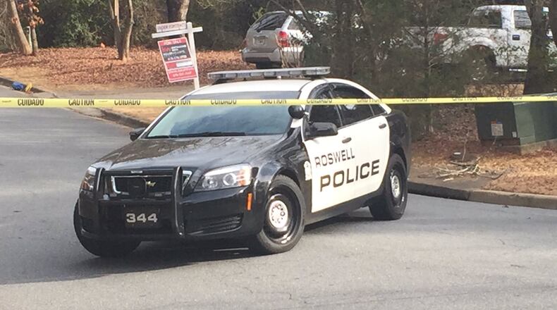 Police were investigating Tuesday afternoon after a woman was found dead in the front yard of a Roswell home. (Credit: Channel 2 Action News)
