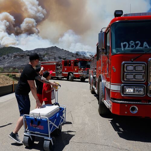 Matt and Kim Brantley bring firefighters snacks and refreshments with their kids during wildfires, Tuesday, May 19, 2026, in Simi Valley, Calif. (AP Photo/Caroline Brehman)