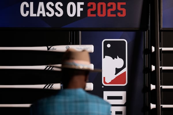 Xavier Scruggs, former professional MLB player looks at specialized bats before the first round of the MLB baseball draft Sunday, July, 13, 2025 in Atlanta. (AP Photo/Mike Stewart)