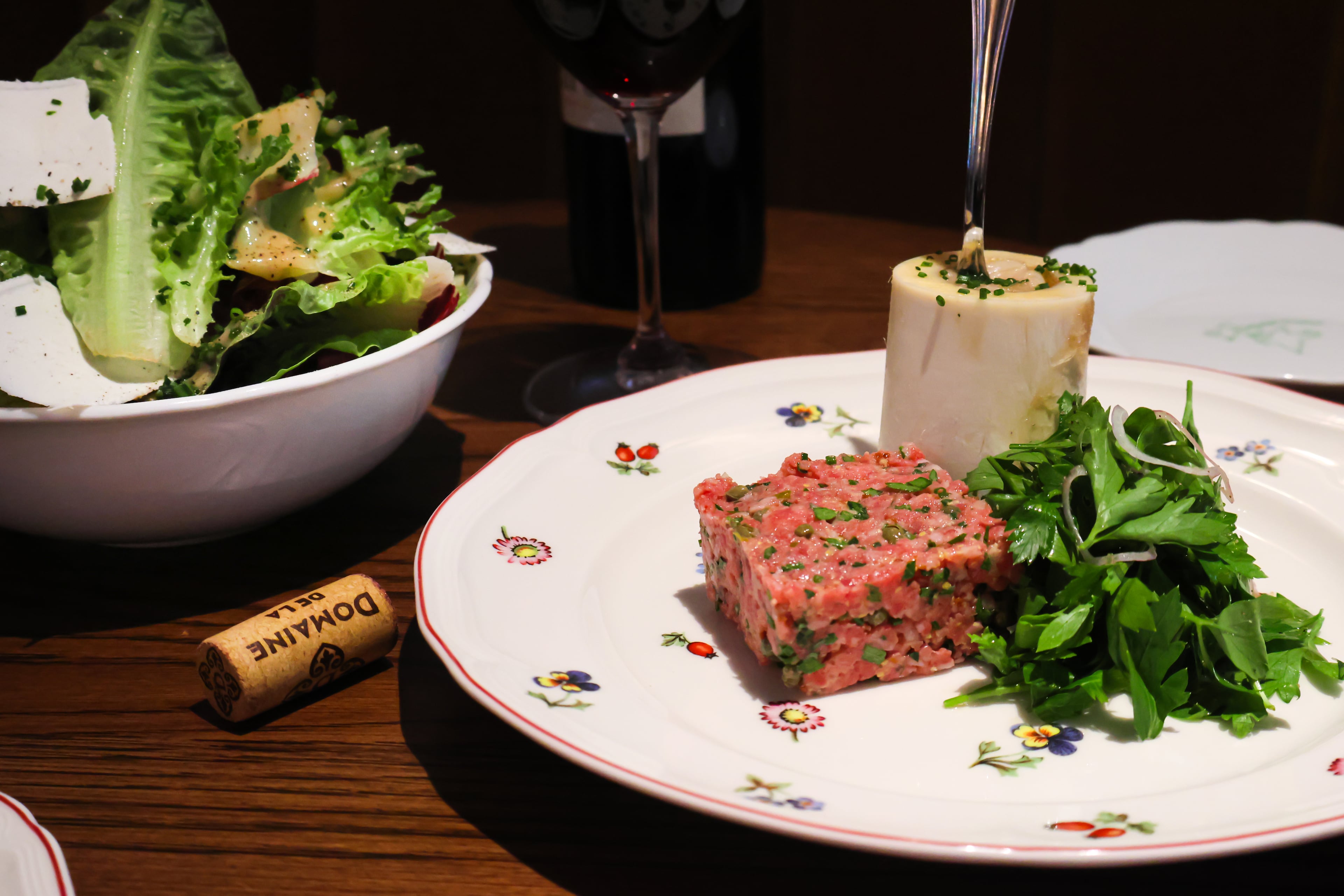 The Salade Maison (left) and Filet Americain are among menu offerings at French brasserie Little Sparrow. (Courtesy of Little Sparrow)