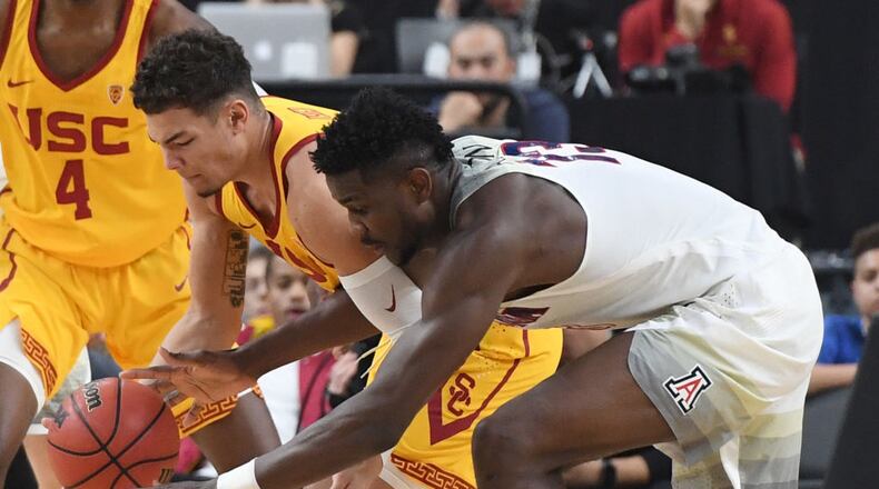 LAS VEGAS, NV - MARCH 10: Jordan Usher #1 of the USC Trojans steals the ball from Deandre Ayton #13 of the Arizona Wildcats during the championship game of the Pac-12 basketball tournament at T-Mobile Arena on March 10, 2018 in Las Vegas, Nevada. The Wildcats won 75-61. (Photo by Ethan Miller/Getty Images)