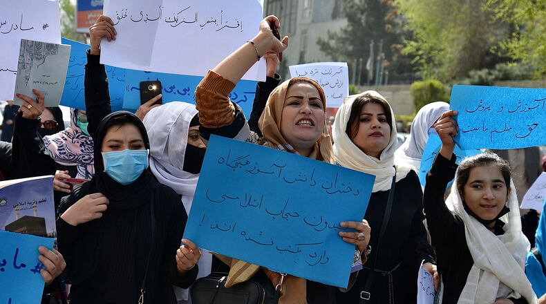 Afghan women and girls take part in a protest in front of the Ministry of Education in Kabul on Saturday, March 26, 2022, demanding that high schools be reopened for girls. Guest columnist Husnia Jamal fled Taliban oppression, such as the law there that women cannot get a college education. She now lives in Georgia. (Ahmad Sahel Arman/AFP/Getty Images/TNS)