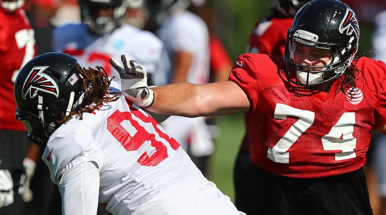 Falcons defensive end Takk McKinley (left) tries to rush around tackle Ty Sambrailo on the first day in pads at training camp Wednesday, July 24, 2019, in Flowery Branch.