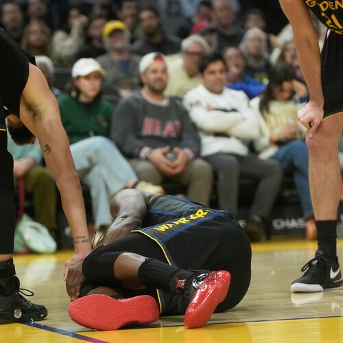 Golden State Warriors guard Stephen Curry, left, checks on forward Jimmy Butler III during the second half of an NBA basketball game against the Miami Heat in San Francisco, Monday, Jan. 19, 2026. (AP Photo/Jeff Chiu)