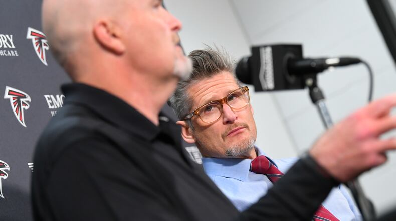 Falcons general manager Thomas Dimitroff listens to coach Dan Quinn during a news conference.