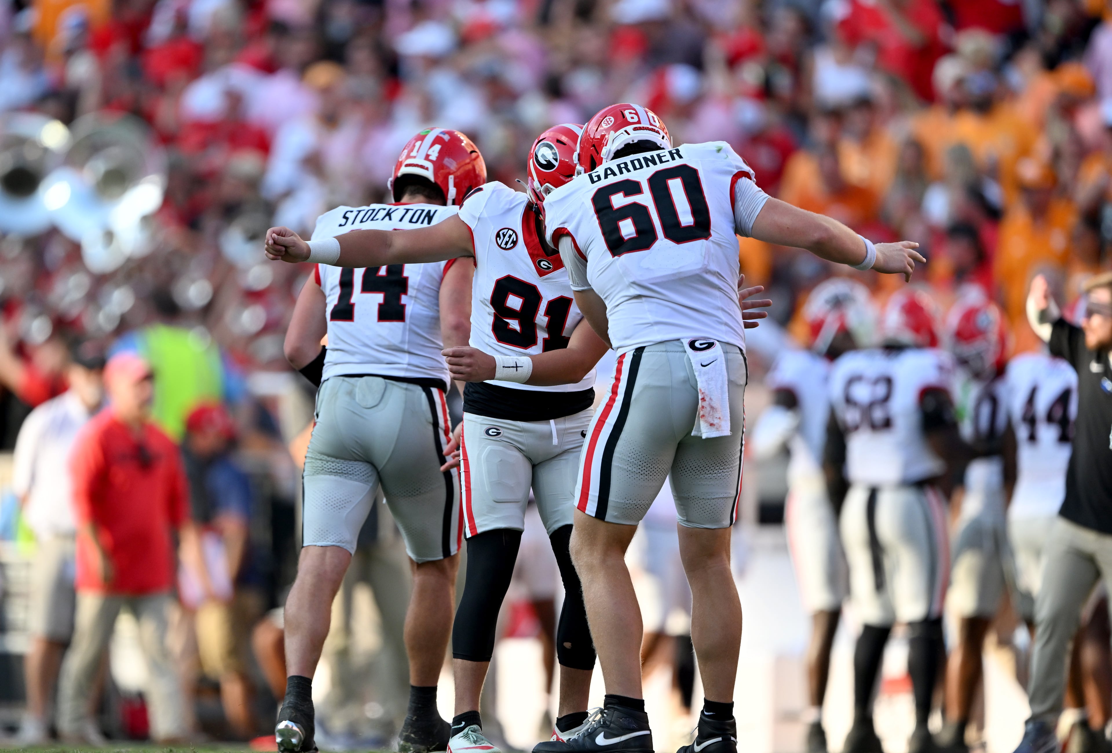Georgia kicker Peyton Woodring (center) celebrates with long snapper Beau Gardner (right) and quarterback Gunner Stockton after Woodring kicked a field goal during the second half against Tennessee at Neyland Stadium on Saturday, Sept. 13, 2025, in Knoxville, Tenn. Georgia won 44-41 in overtime. (Hyosub Shin/AJC)