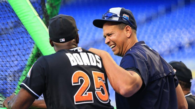 Former New York Yankees designated hitter Alex Rodriguez, right, talks with Miami Marlins hitting coach Barry Bonds before an exhibition baseball game in April. (AP photo)