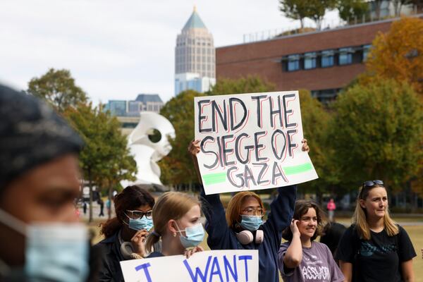 A student demonstrator holds a sign, “End the Siege of Gaza,” during a rally in support of Palestinian, Arab and Muslim students on the Tech Green on the Georgia Tech campus, Wednesday, Oct. 25, 2023, in Atlanta. (Jason Getz / Jason.Getz@ajc.com)