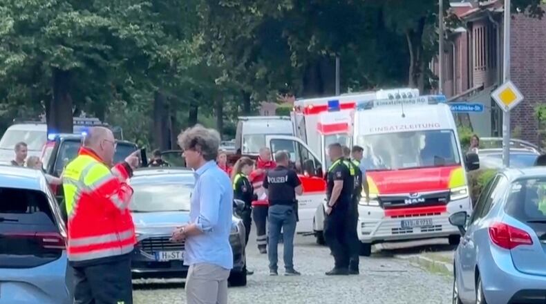 In this image taken from a video, emergency responders, residents and police in Stade, Germany, Monday, June 29, 2026 after five people were killed in a shooting on Monday at a youth welfare facility in the northern German town of Stade, police said. (NWM-TV via AP)