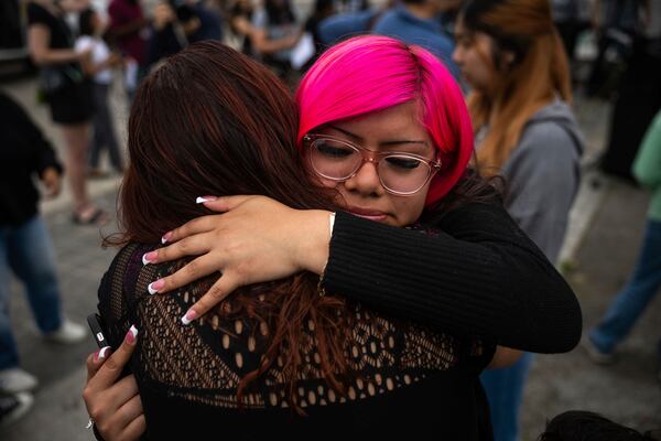 Jaslyn Hernandez, daughter of a car wash worker, is embraced during a press conference with families of detained car wash workers Wednesday, June 11, 2025, in Culver City, Calif. (AP Photo/Ethan Swope)