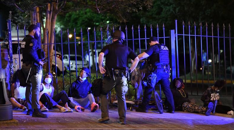 May 30, 2020 Atlanta - Police arrested protestors after curfew Saturday, some vandalizing property, as protests began for a second day in downtown Atlanta on Saturday, May 30, 2020. A second day of protests Saturday began with a crowd outside the Governor's Mansion and grew to include demonstrations in downtown Atlanta. Mayor Keisha Lance Bottoms implemented a curfew for the city following a night of chaotic protests Friday that led to vandalism and looting in parts of downtown Atlanta and Buckhead. (Hyosub Shin / Hyosub.Shin@ajc.com)