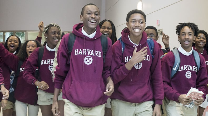 7/12/2019 — Atlanta, Georgia — Members of the Harvard Diversity Project react as their family, friends and supporters greet them at the domestic terminal at Hartsfield Jackson International Airport in Atlanta, Friday, July 12, 2019. The group, an Atlanta-based pipeline of the Harvard Debate Council, returned to Atlanta as champions of Harvard University’s annual international debate tournament. Two of the students, Don Jr. Roman (fourth from left) and Keith Harris (third from right) achieved an unprecedented, undefeated record. (Alyssa Pointer/alyssa.pointer@ajc.com)
