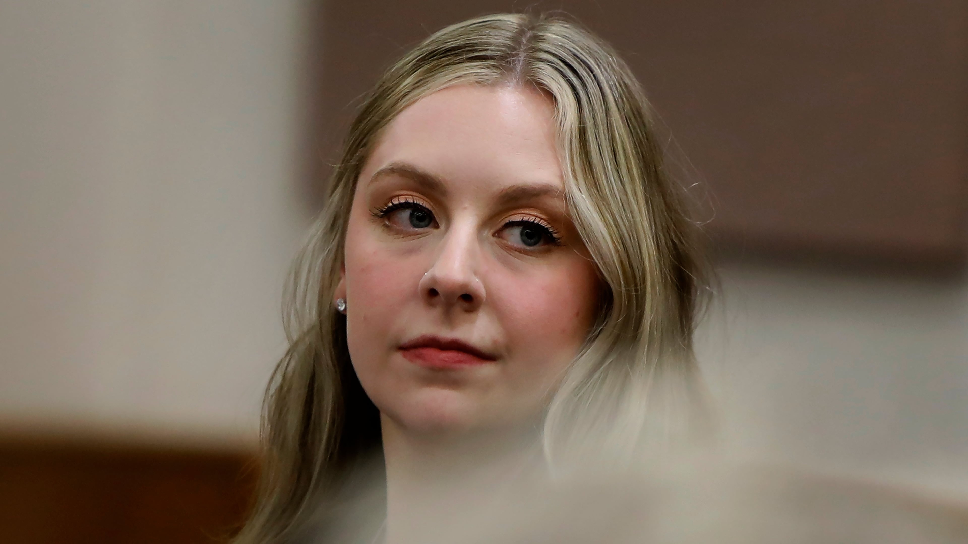 Former Richneck Elementary School teacher Abby Zwerner looks back into the courtroom during her civil lawsuit trial, Tuesday, Oct. 28, 2025, in Newport News, Va. (Stephen M. Katz/The Virginian-Pilot via AP, Pool)