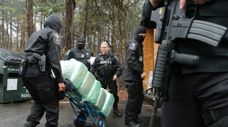 DeKalb County police showed off the spoils of its 2013 anti-drug campaign at a news conference on Friday. Police said they seized $128 million in drugs and also displayed weapons and cash confiscated. The team made 989 arrests for the year.