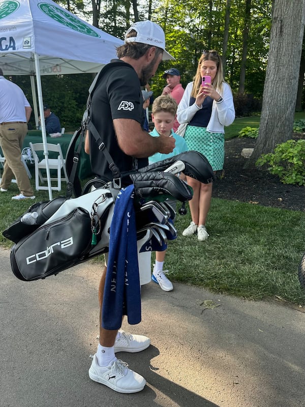Max Homa stops to sign an autograph after his U.S. Open qualifier carrying his own bag after a split with his caddie, on Monday, June 2, 2025, in Columbus, Ohio. (AP Photo/Doug Ferguson)