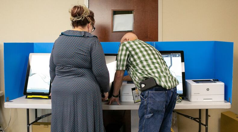 Paulding County Elections Supervisor Deidre Holden operates a voting machine Monday. Paulding tested Georgia’s new voting machines during local elections. Paulding is one of six counties to try the new machines that will be in all polling stations in the state for the first presidential primary election March 24. (Photo/Rebecca Wright for the Atlanta Journal-Constitution)