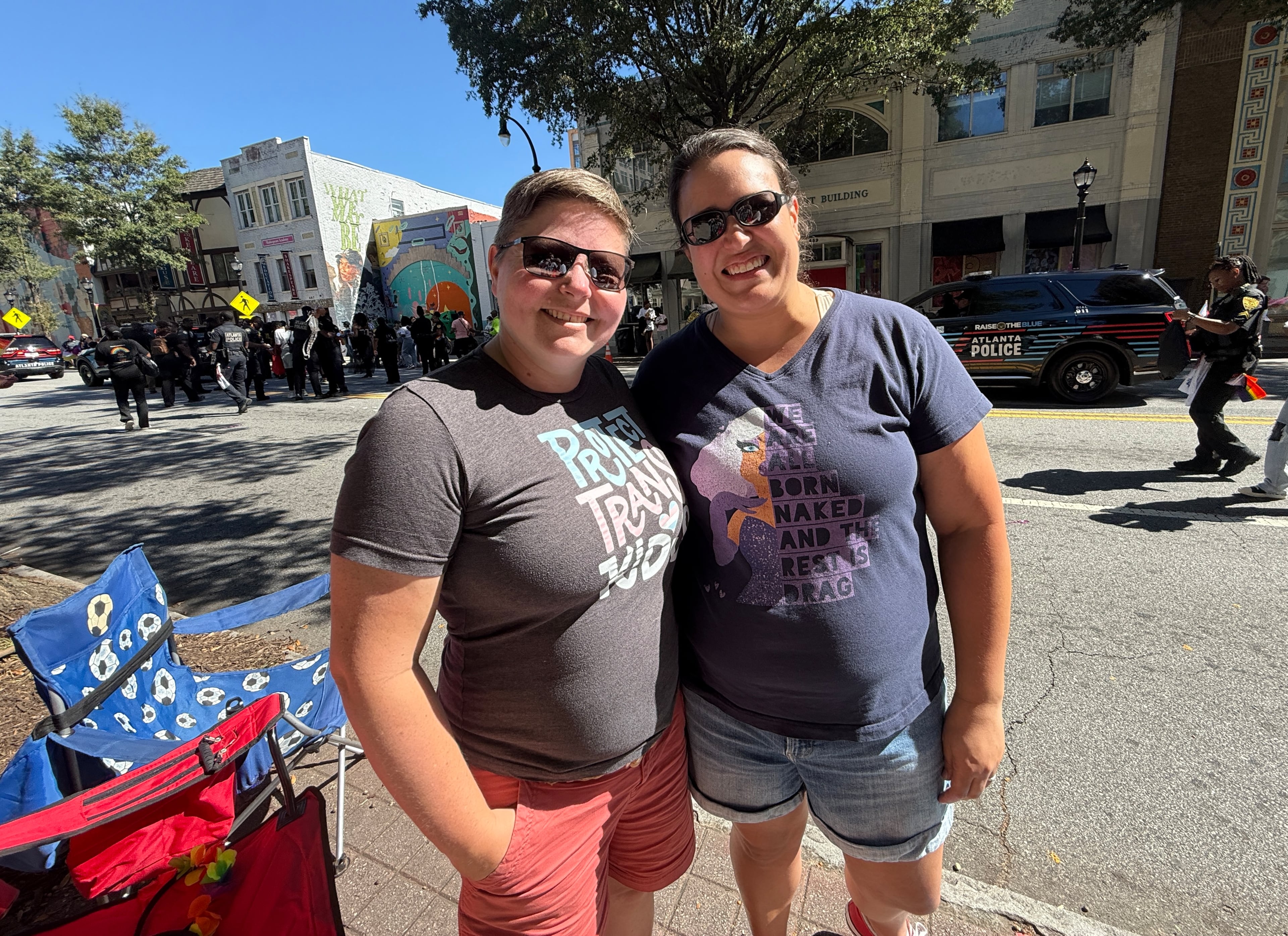 Kelley Napier (left), 42, from DeKalb County brought her wife and four children — ages 4, 6, 6 and 9 — to their annual spot on the sidewalk near St. Luke's Episcopal Church to watch the Atlanta Pride Parade. Napier has been coming to the Pride celebration for 20 years. (Danielle Charbonneau/AJC)