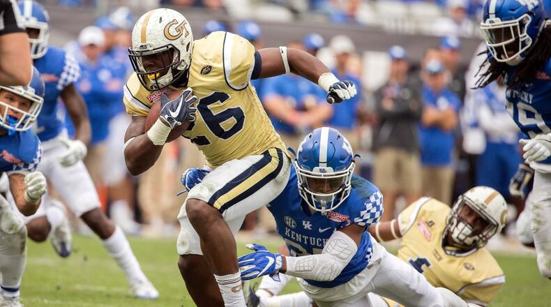 Georgia Tech running back Dedrick Mills (26) is tackled by Kentucky safety Mike Edwards (27) during the TaxSlayer Bowl in Jacksonville, Fla., on Dec. 31, 2016.