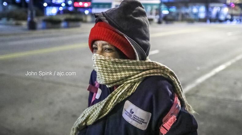 With temperatures in the 20s Tuesday morning, Corine Riley made sure to bundle up as she stood on Peachtree and Wall streets in downtown Atlanta.