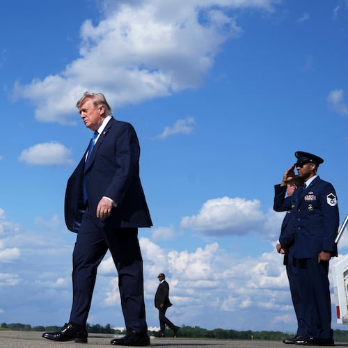 President Donald Trump, center, walks from Air Force One at Morristown Municipal Airport in Morristown, N.J., Friday, July 31, 2026, from Camp David, the presidential retreat. (AP Photo/Jacquelyn Martin)