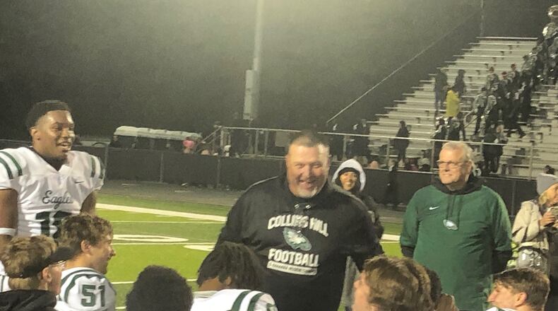 Collins Hill coach Lenny Gregory talks to his team after a 40-10 win over Mill Creek on Oct. 30, 2021. The win gave the No. 1-ranked Eagles an undefeated season and a second straight Region 8 championship.