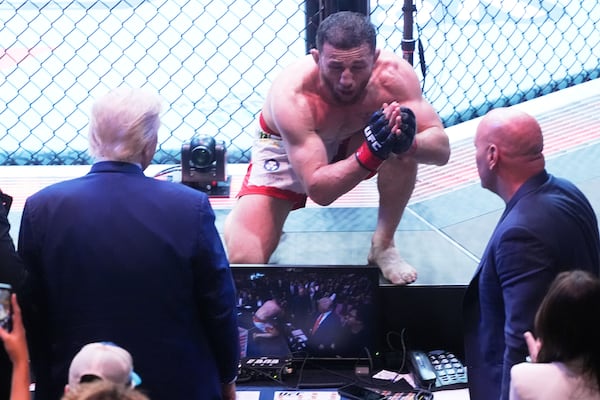 President Donald Trump congratulates Georgia's Merab Dvalishvili, after he won his bantamweight title bout against Sean O'Malley, during the UFC-316 mixed martial arts event, at the Prudential Center, Saturday, June 7, 2025, in Newark, N.J. (AP Photo/Manuel Ceneta)