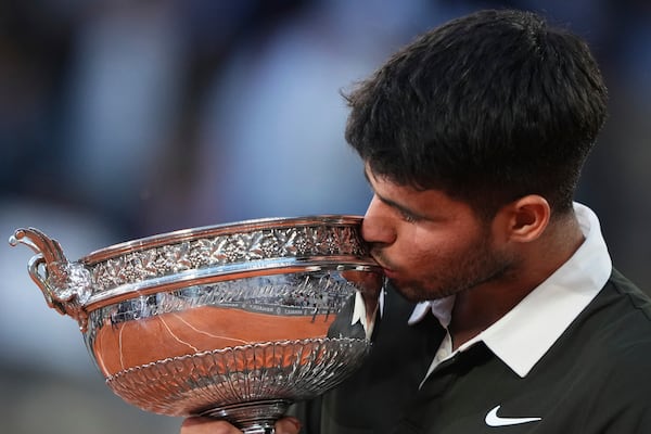 Spain's Carlos Alcaraz celebrates with the trophy after winning the final match of the French Tennis Open against Italy's Jannik Sinner at the Roland-Garros stadium in Paris, Sunday, June 8, 2025. (AP Photo/Lindsey Wasson)
