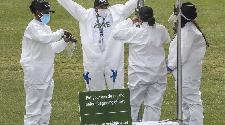 Core workers prepare for testing on Thursday, April 30, 2020 at the Home Depot Backyard. Los Angeles-based CORE Response and the Arthur M. Blank Family Foundation on Thursday opened a coronavirus testing site at Mercedes-Benz Stadium. The testing center is at the Home Depot Backyard adjacent to the stadium, offered free tests to people with appointments from 10 a.m. to 4 p.m. The site will operate Monday-Friday for at least the next several weeks. David Boden, a volunteer with CORE, said the nonprofit, founded by actor Sean Penn, has operated about a half-dozen sites in southern California. The center will offer both drive-through and walk-up service. Tests are self-administered via an oral swab and those tested will be contacted by the testing company with results. State Rep. Mark Newton, R-Augusta, a physician who helped arrange the testing site, said it will serve people with COVID-19 symptoms, health workers, first responders as well as asymptomatic food service workers. Workers who are sick are not permitted to return to work, under the new restaurant rules, but it’s also known that asymptomatic people carry the virus. Newton said that this center will help food workers know if they have the virus, even if they show no signs, offering assurance to their employers, co-workers and patrons. JOHN SPINK / JSPINK@AJC.COM
