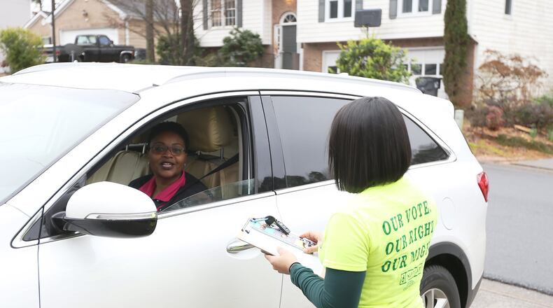 2/22/19 - Norcross - Michelle Sanchez with the New Georgia Project Action Fund speaks with Kimberley Coleman while canvassing in support of the MARTA referendum on Friday, February 22, 2019 in Norcross, Georgia. Early voting for the referendum begins on February 25. The election is March 19. The New Georgia Project Action Fund have already knocked on thousands of doors and don’t plan to slow down anytime soon. EMILY HANEY / emily.haney@ajc.com