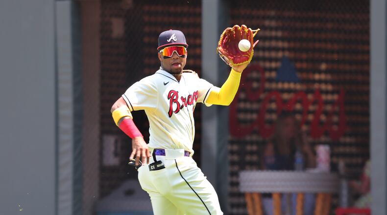 Braves outfielder Ronald Acuna catches a fly ball during a May 2021 game against the Pittsburgh Pirates at Truist Park in Atlanta. (AJC file photo/ccompton@ajc.com)
