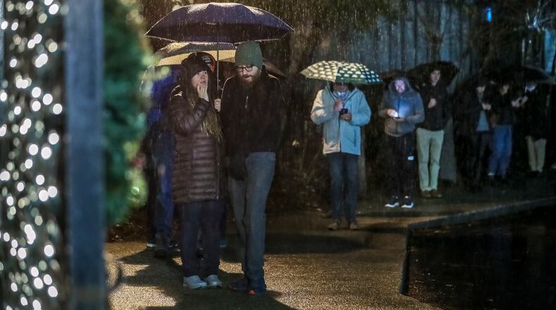 Voters lined up in the rain on Tuesday, Dec. 6, 2022, at Park Tavern in Atlanta for the U.S. Senate runoff between Democrat Raphael Warnock and Republican Herschel Walker. (John Spink / John.Spink@ajc.com)