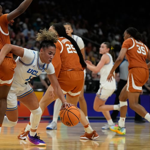UCLA guard Kiki Rice (1) drives against Texas guard Bryanna Preston, left, during the first half of a women's NCAA college basketball tournament semifinal game at the Final Four, Friday, April 3, 2026, in Phoenix. (AP Photo/Ross D. Franklin)