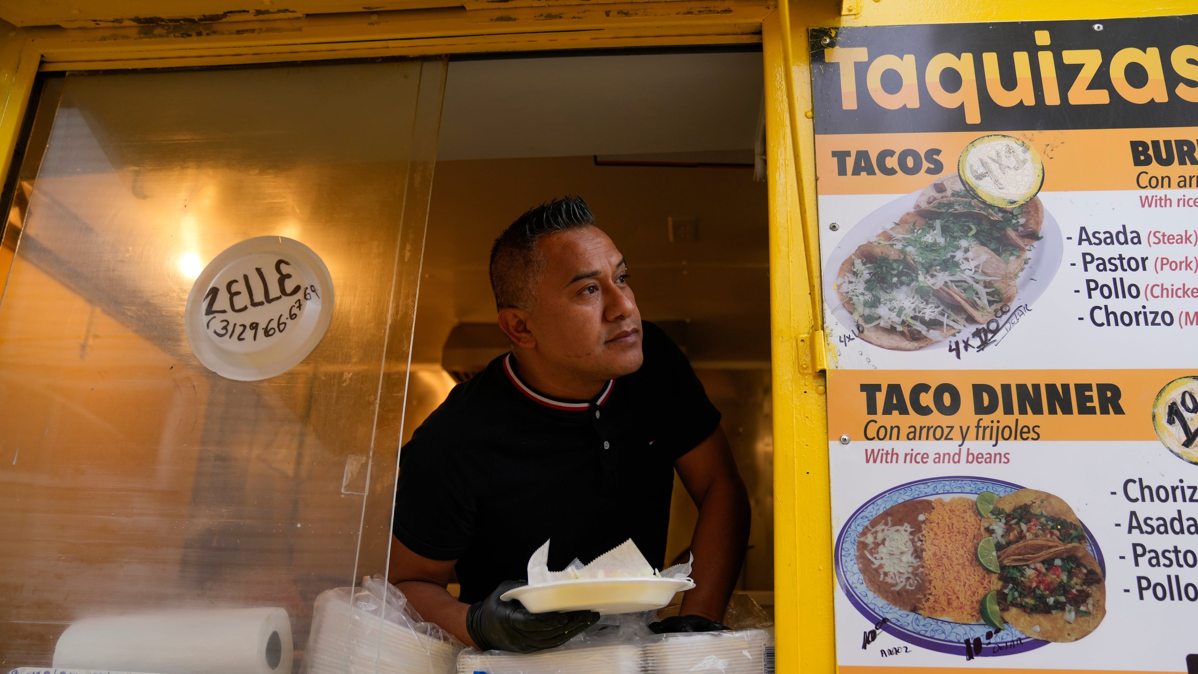 Rafael Hernandez, originally from Mexico, sells food from his family's food truck, Nov. 6, 2025, in Chicago. (AP Photo/Erin Hooley)