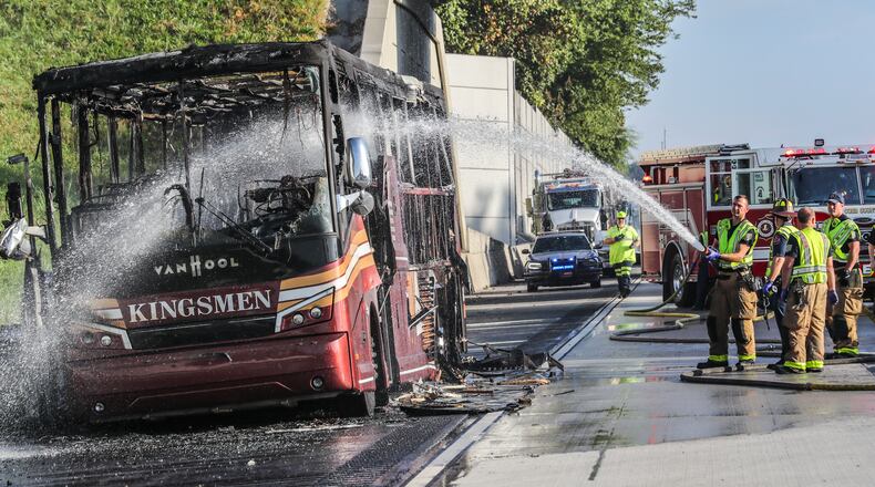 October 13, 2021 Cobb County: Cobb County firefighters worked to douse a Kingsmen tour bus that partially blocked a major interstate for hours in Cobb County after the bus burst into flames on I-285 on Oct. 13, 2021. The burned-out bus is sitting in the shoulder lane of I-285 South near Paces Ferry Road. (John Spink / John.Spink@ajc.com)