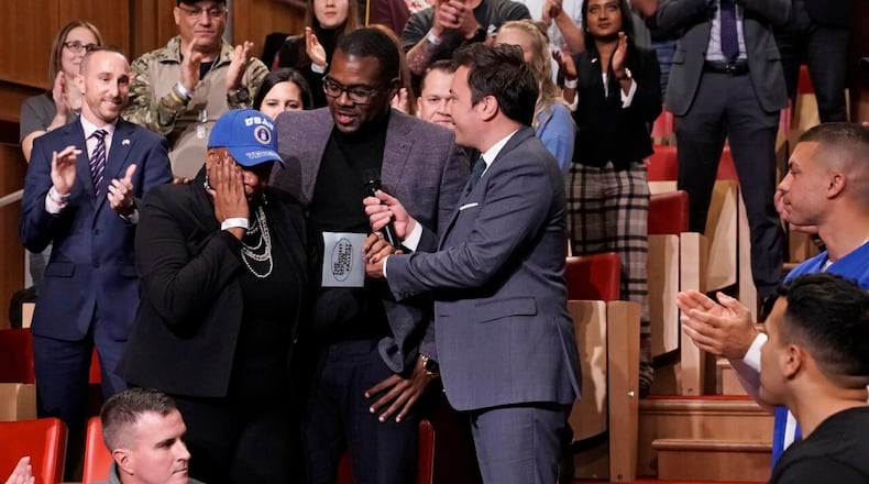 Vernitta Love, left,  found on Veteran's Day she had received a $50,000 grant for home repairs from the Home Depot Foundation on the Tonight Show Starring Jimmy Fallon.  Her son, Aaron Love, center, nominated her for the grant.