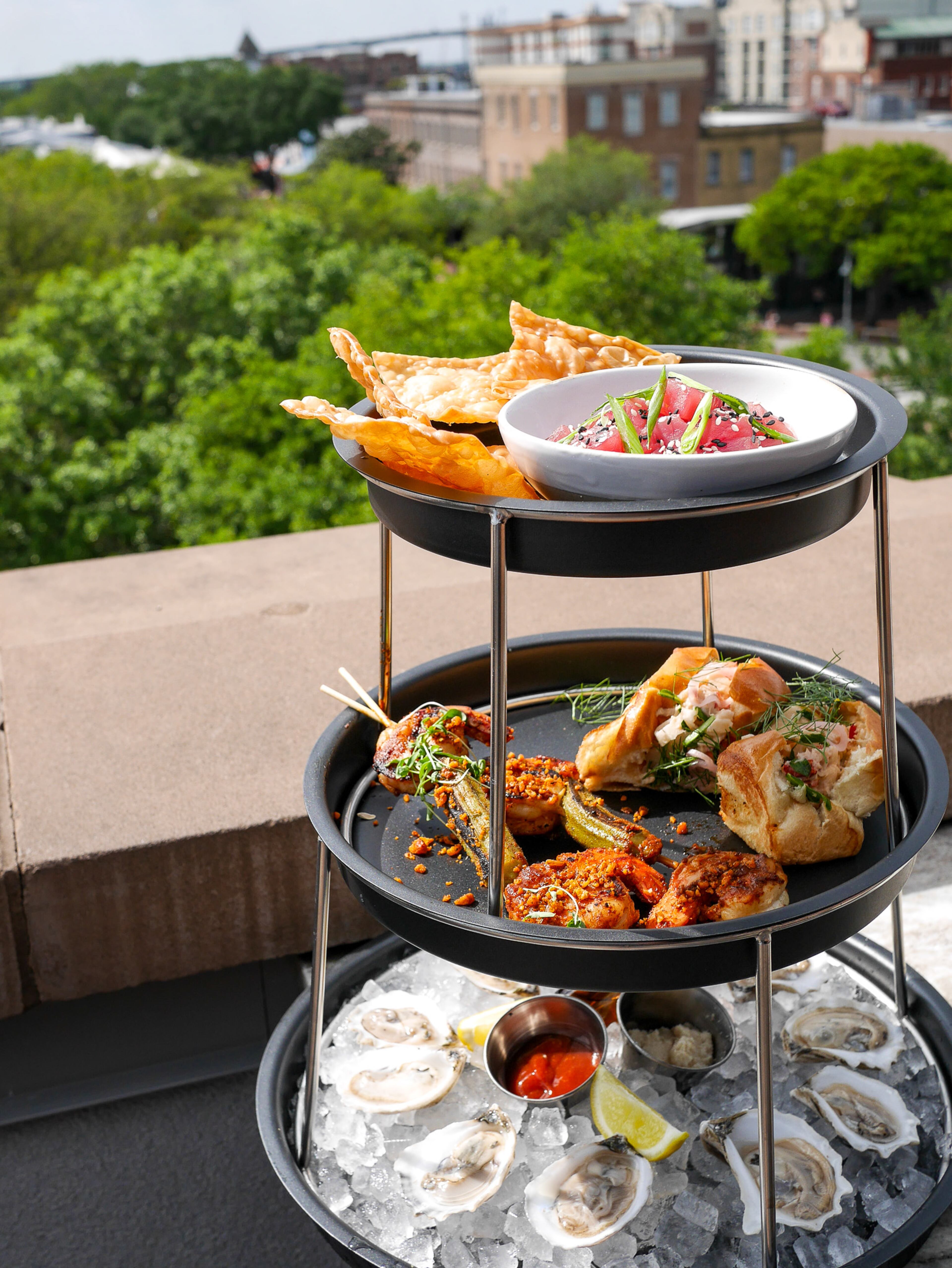 The Neon Fish's seafood tower with Sorry Charlie's Bull River Oysters, grilled shrimp skewers, mini lobster rolls and tuna tartare served with crispy wonton chips. (Courtesy of Sorry Charlie's)